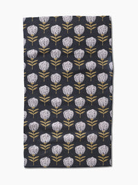 Floral patterned towel with white flowers on a dark background
