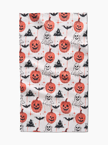 Halloween-themed fabric with pumpkins, ghosts, and bats on a white background