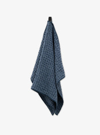 Blue textured towel on a white background