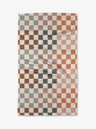 Checkered towel with a pattern of brown, beige, and gray squares on a white background