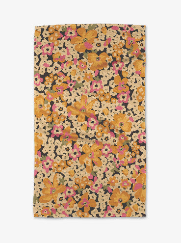 Floral patterned fabric with orange, pink, and yellow flowers on a dark background