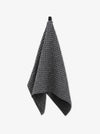 Gray waffle-textured towel on a white background