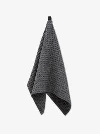 Gray waffle-textured towel on a white background
