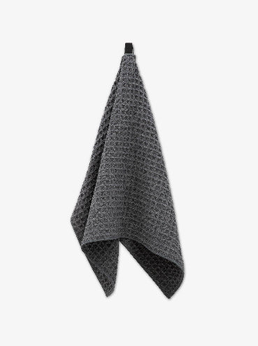 Gray waffle-textured towel on a white background