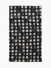 Black fabric with beige moon phase pattern on a white background