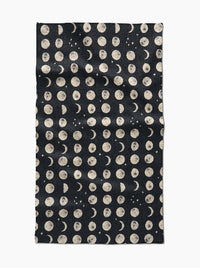 Black fabric with beige moon phase pattern on a white background
