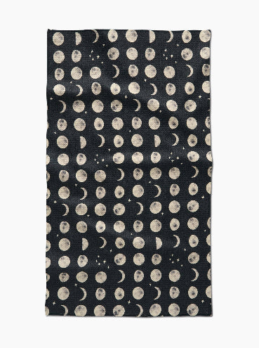 Black fabric with beige moon phase pattern on a white background