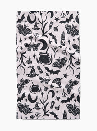 Patterned fabric with black Halloween-themed designs on a white background