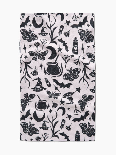 Patterned fabric with black Halloween-themed designs on a white background